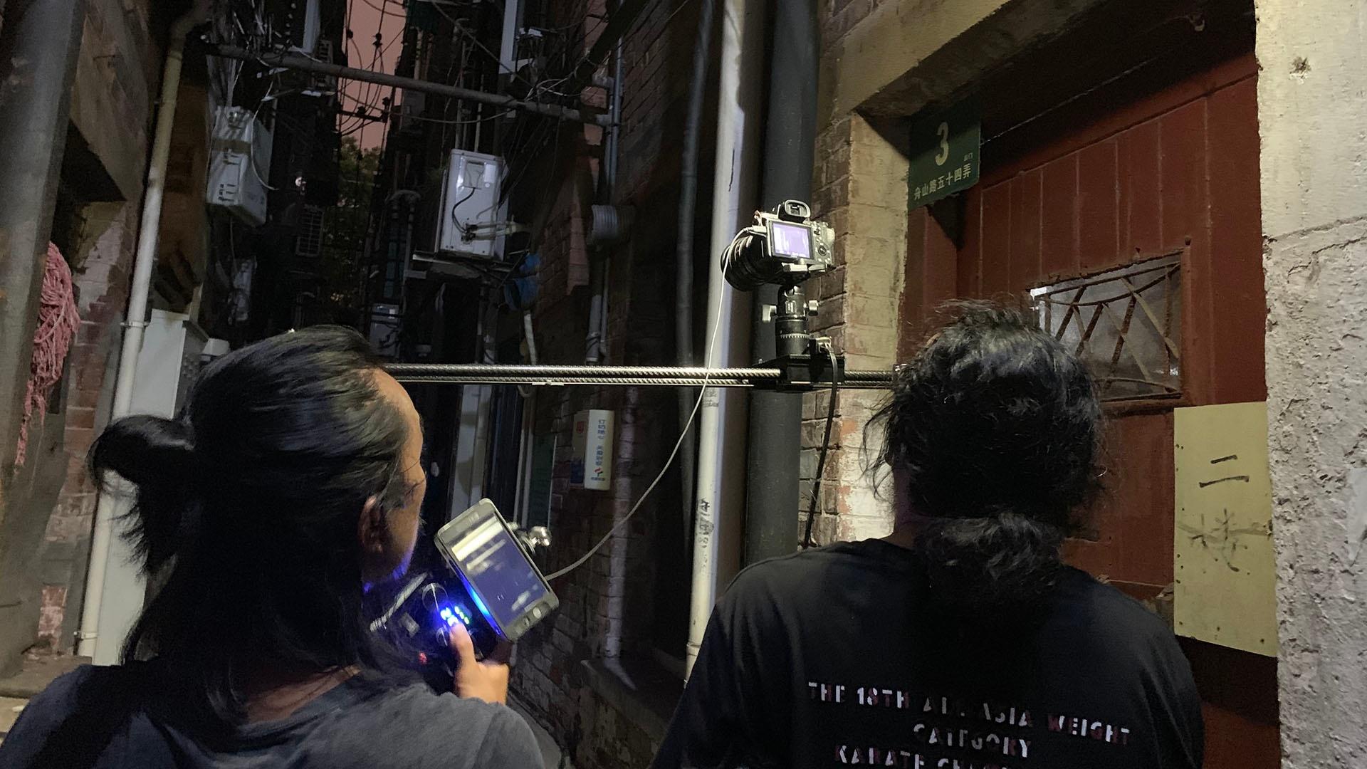 Jason Wong and assistant filming in the Shanghai ghetto.