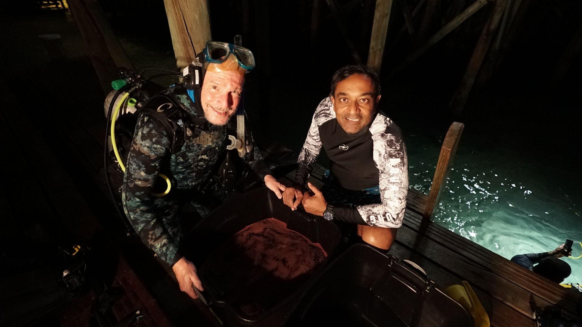 Image of a Peter Harrison and Dr. M. Sanjayan in diving suits after successful coral spawning.