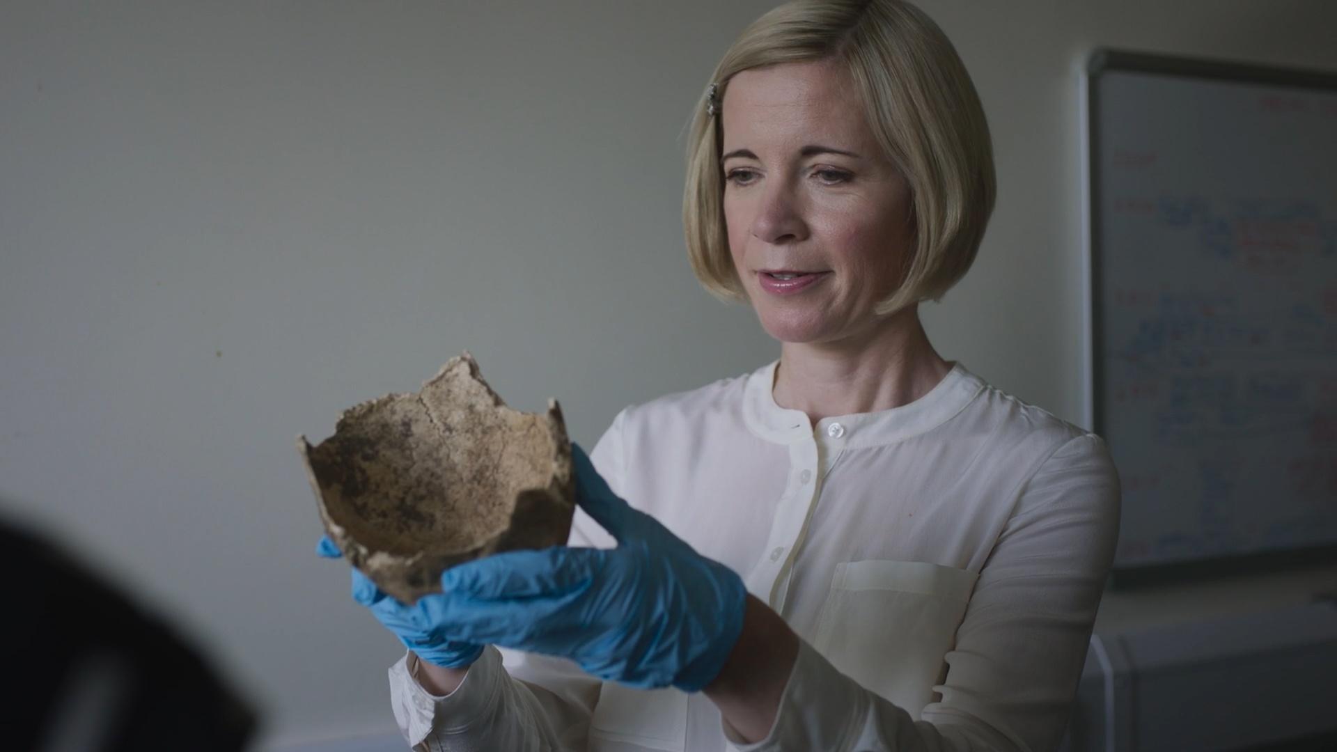 Lucy holding a skull from a set of human remains sent to Turi King at Leicester University.