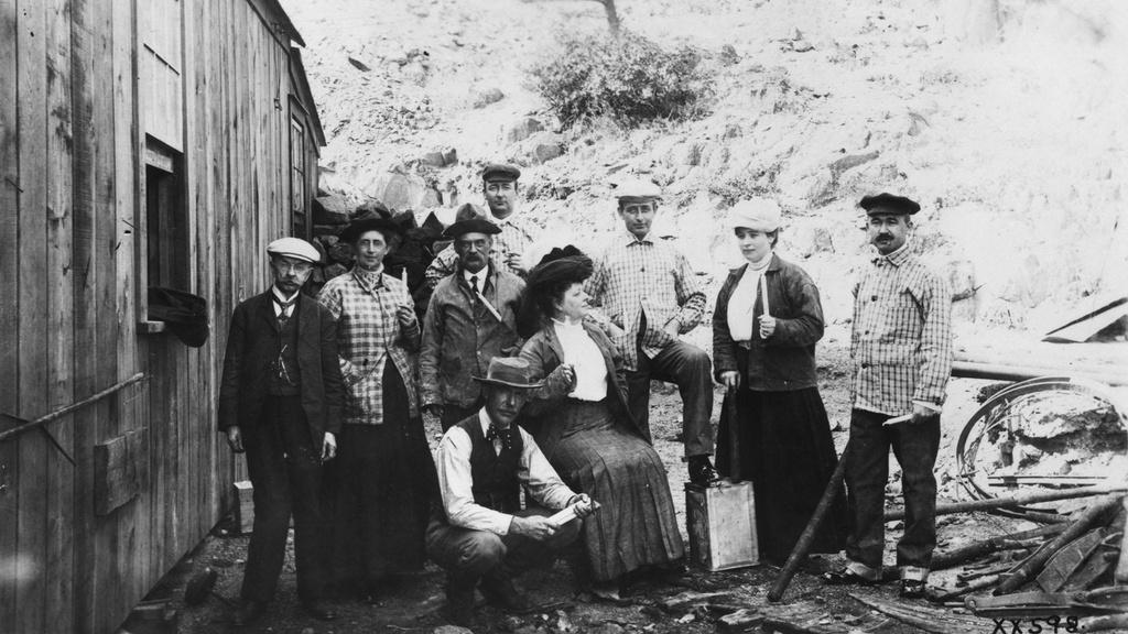 Black and white image of men and women in a group.