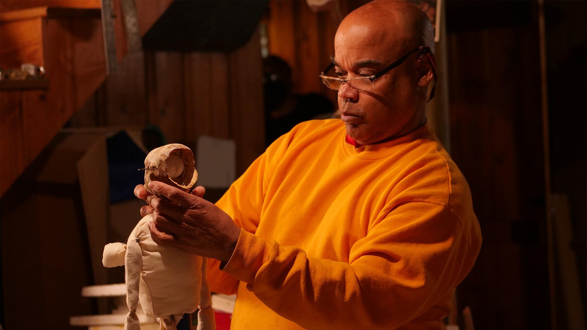 Puppet maker Schroeder Cherry adjusts the head on his new puppet