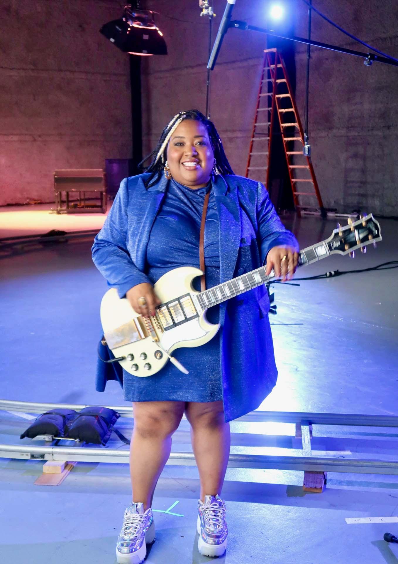Celisse Henderson poses for a photo with her guitar on the set of GOSPEL