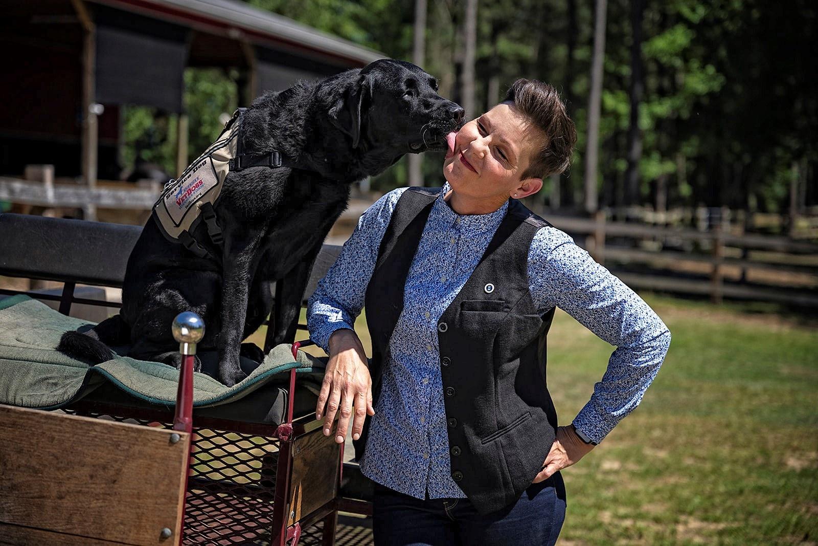 America’s VetDog Charlie gives “After Action” host Stacy Pearsall an affectionate kiss 