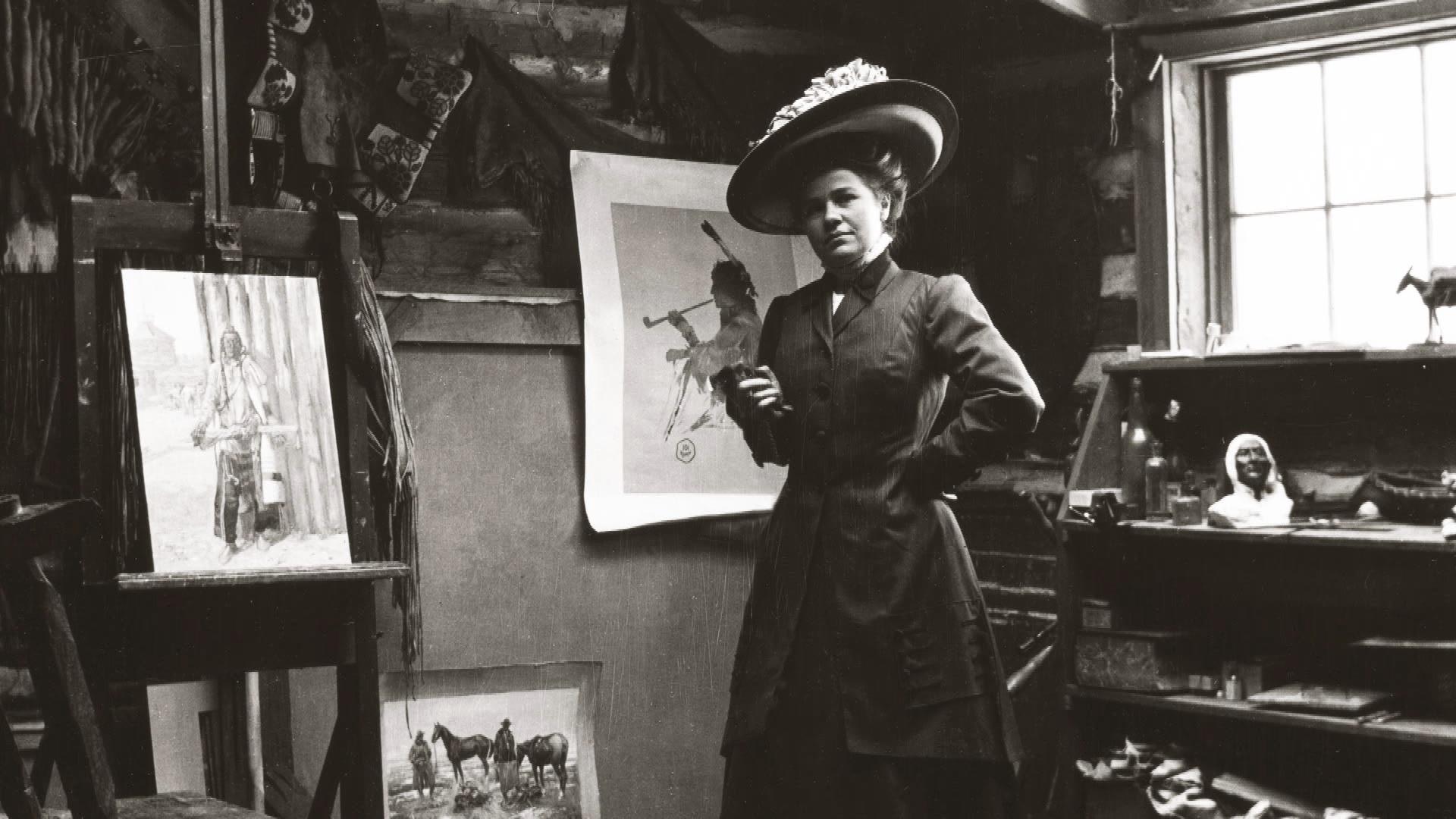Image of Nancy Russell standing in Charlie's art studio.