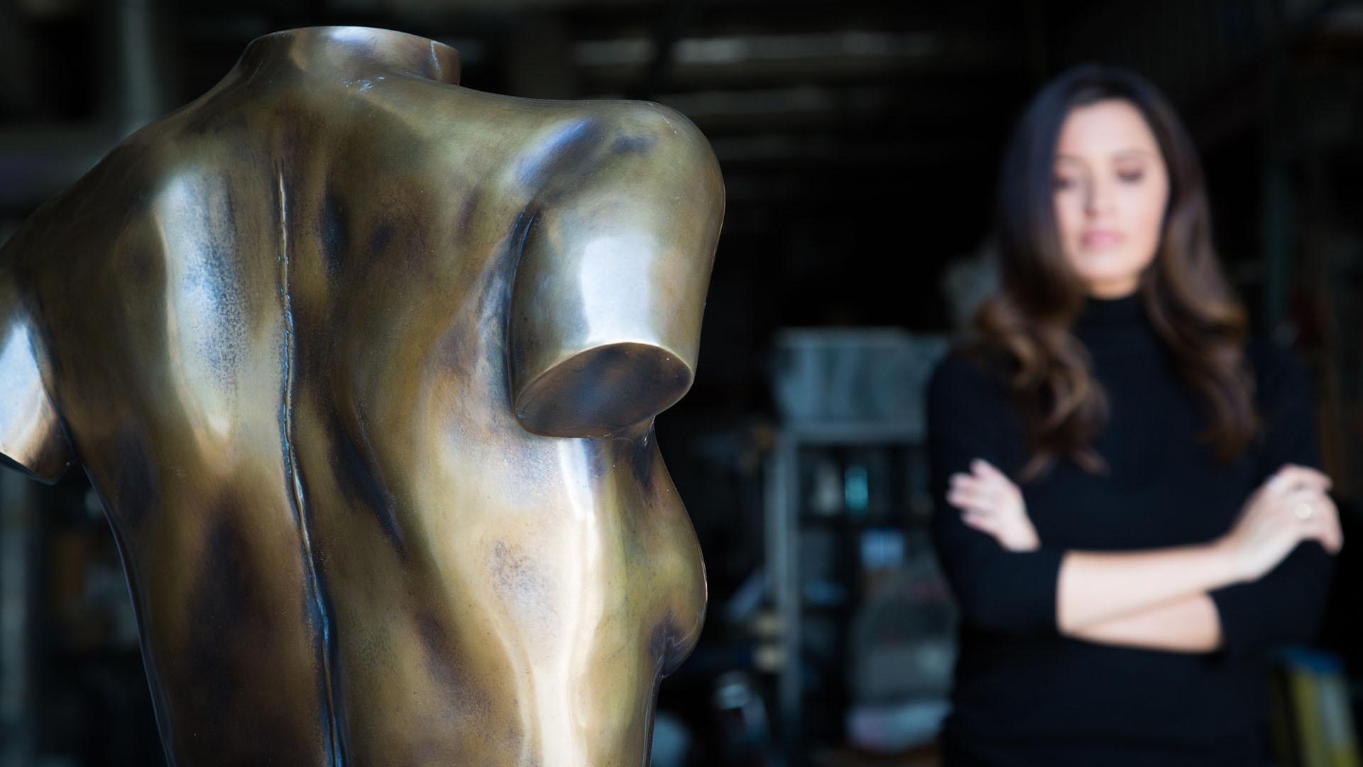 Alejandra Campoverdi contemplates the bronze sculpture of her torso.