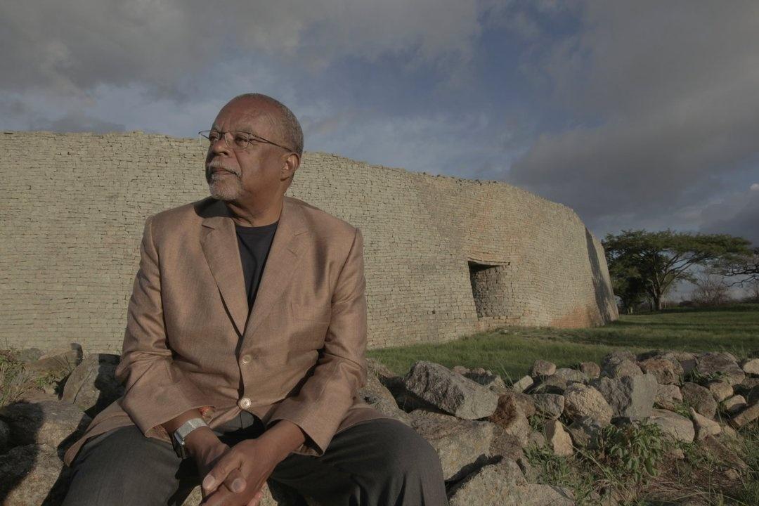 Henry Louis Gates, Jr. sits in front of the ruins of Great Zimbabwe, a once important trading center in the Kingdom of Zimbabwe.
