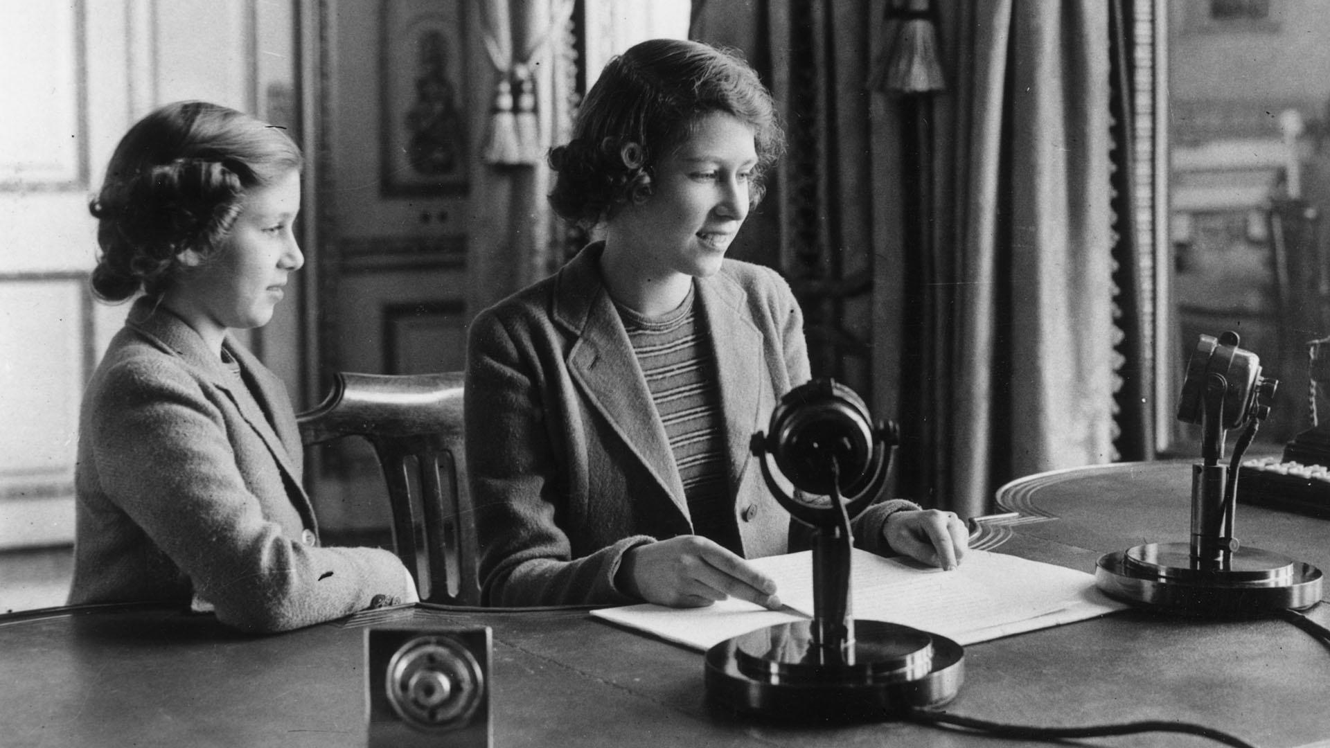 Princess Elizabeth and Princess Margaret at the microphone for Elizabeth's first broadcast.