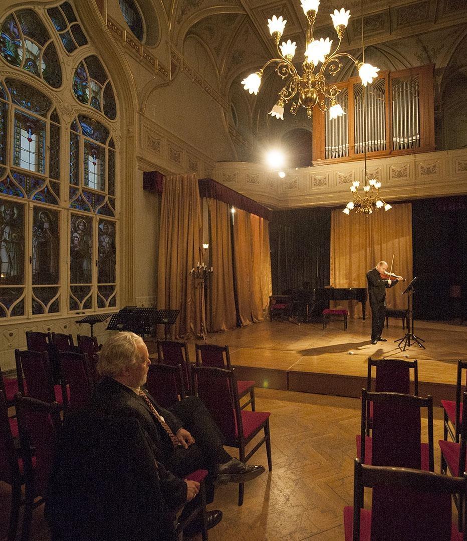 Composer Eric Funk listens to Vilmos Oláh rehearse.