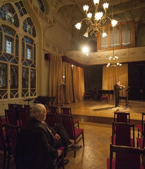 Composer Eric Funk listens to Vilmos Oláh rehearse.