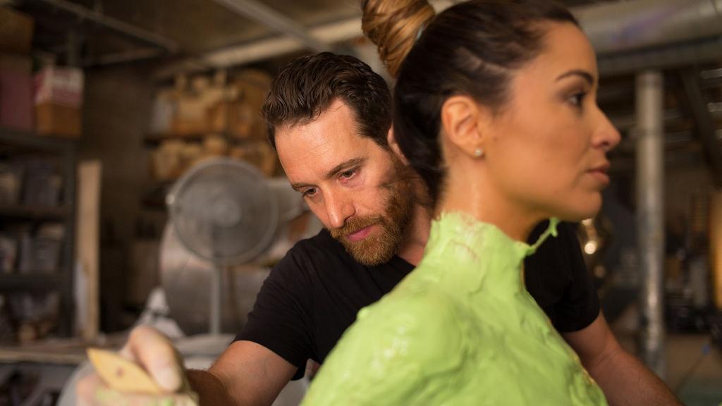 Sculptor Nick Petronzio applies latex to Alejandra Campoverdi’s torso during body-casting process.