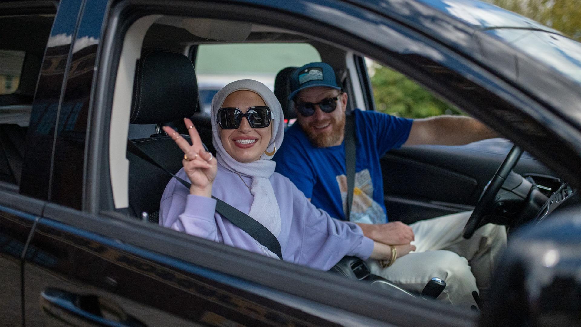 Mona Haydar flashes a peace sign as husband Sebastian Robins begins their day of driving.