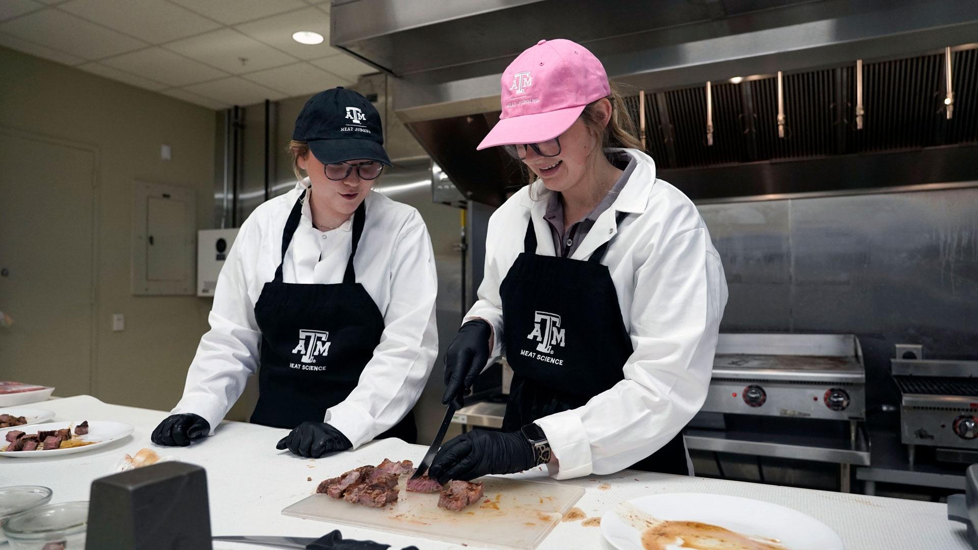 Two Animal Science students cut steak as part of Dr. Rhonda Miller's Sensory Lab, as featured on Season 2 of "Texas A&M Today."