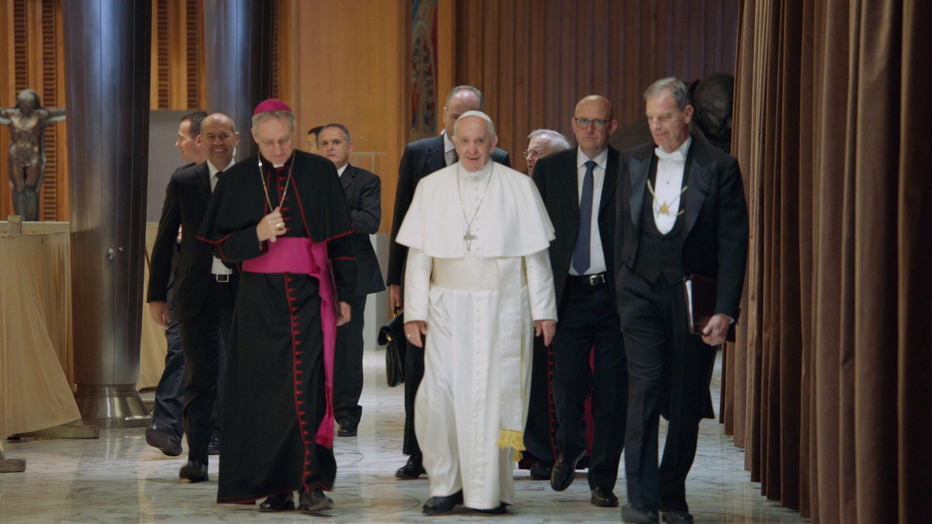 Holy Father Pope Francis walking with Vatican delegation inside the Vatican.