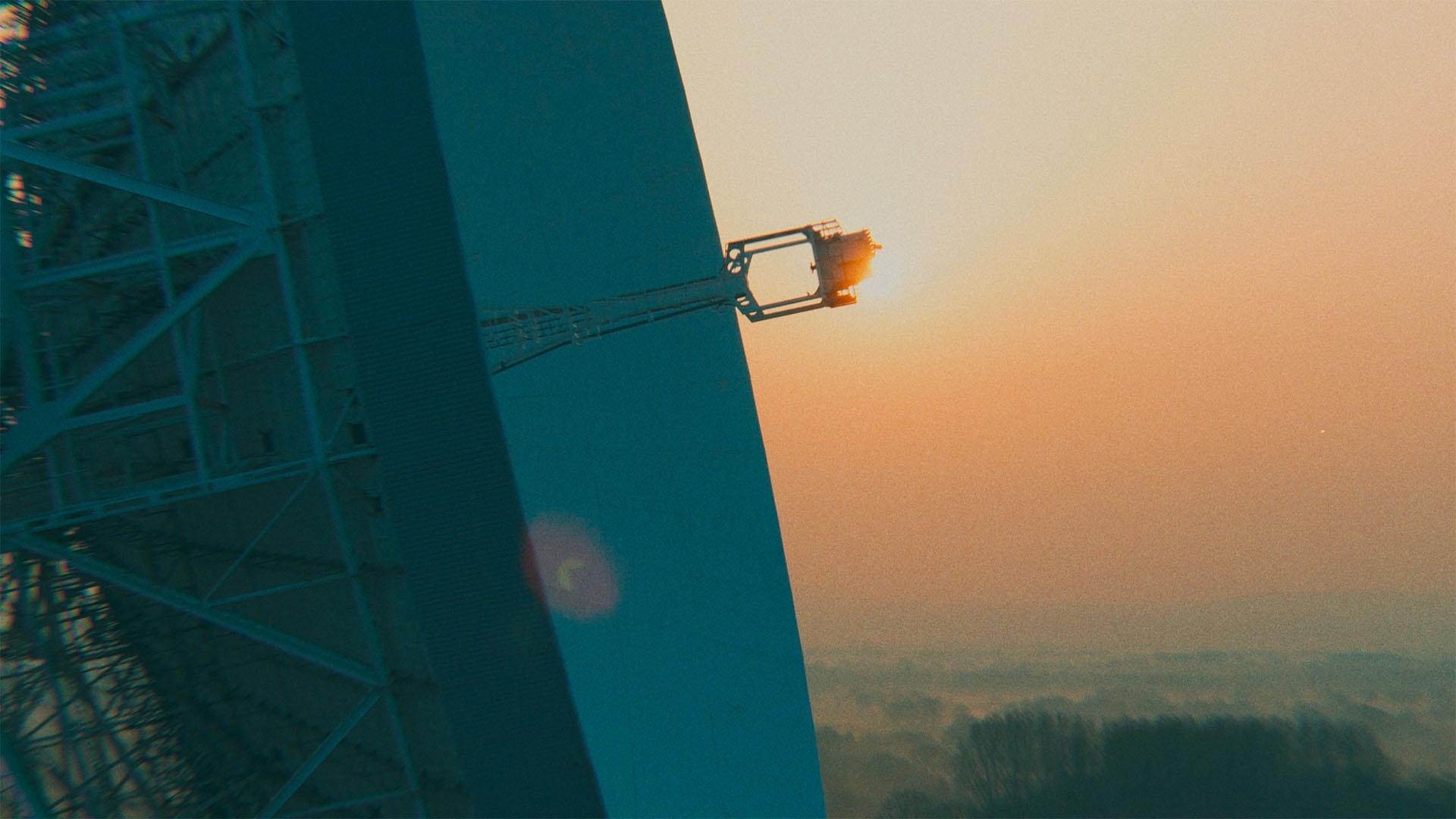 The sun rises behind the Lovell Telescope at Jodrell Bank Observatory.