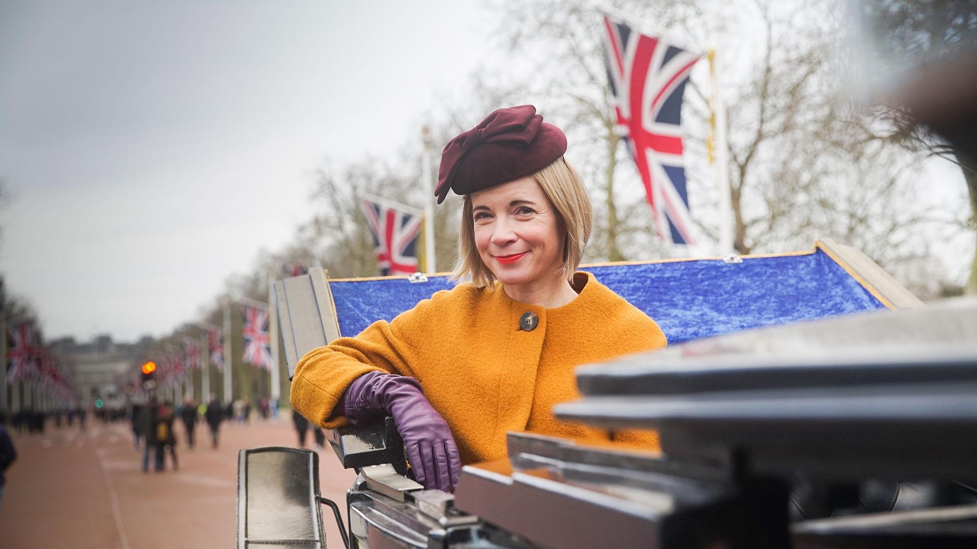 Lucy Worsley in a carriage on The Mall, London.
