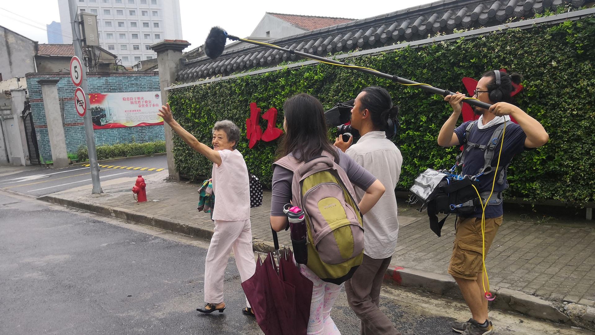 A camera crew follows Mrs. Zhou through Shanghai’s former Jewish ghetto.