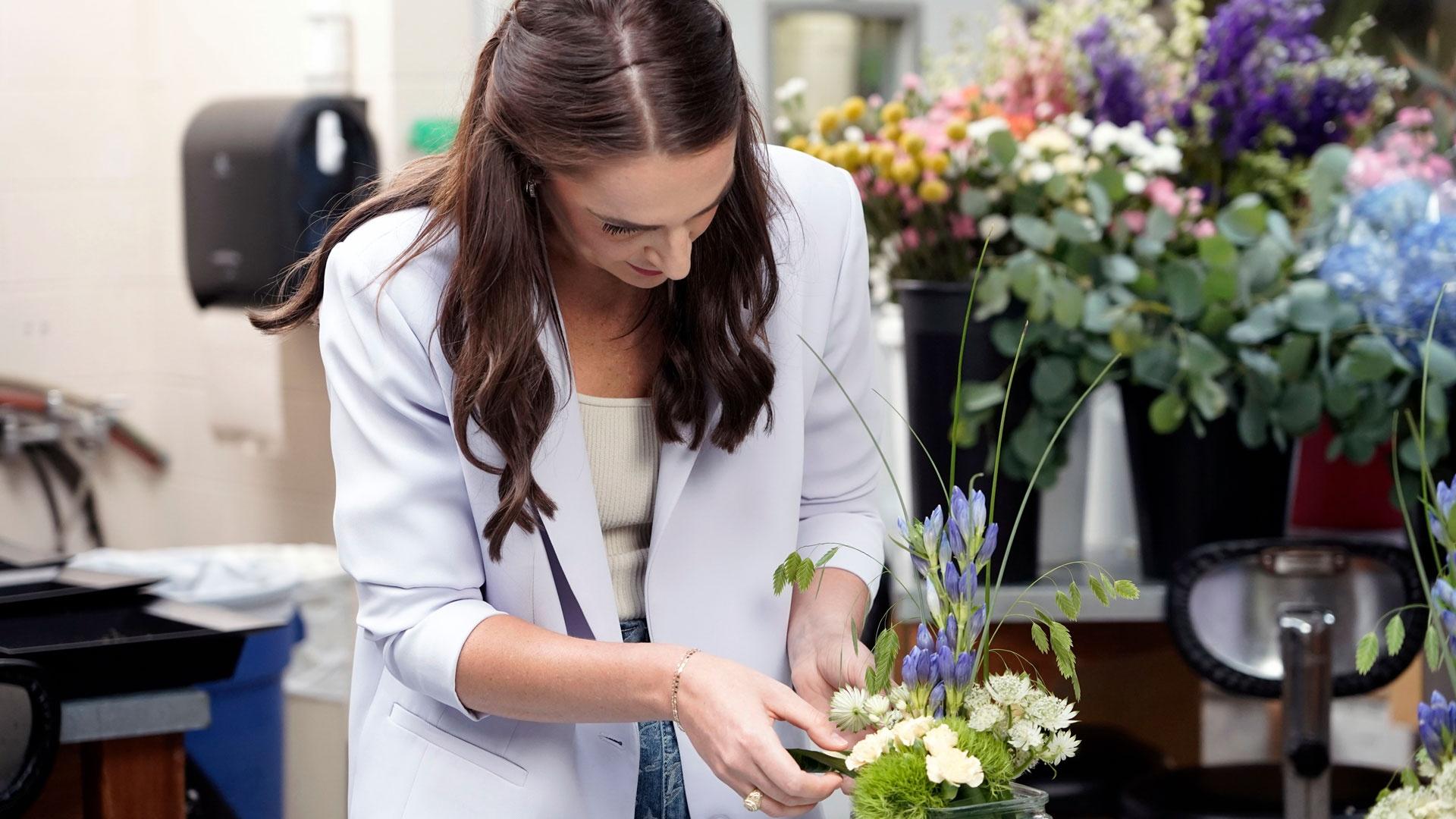 Chelsea Reber works on a floral arrangement, as featured on Season 2 of "Texas A&M Today."