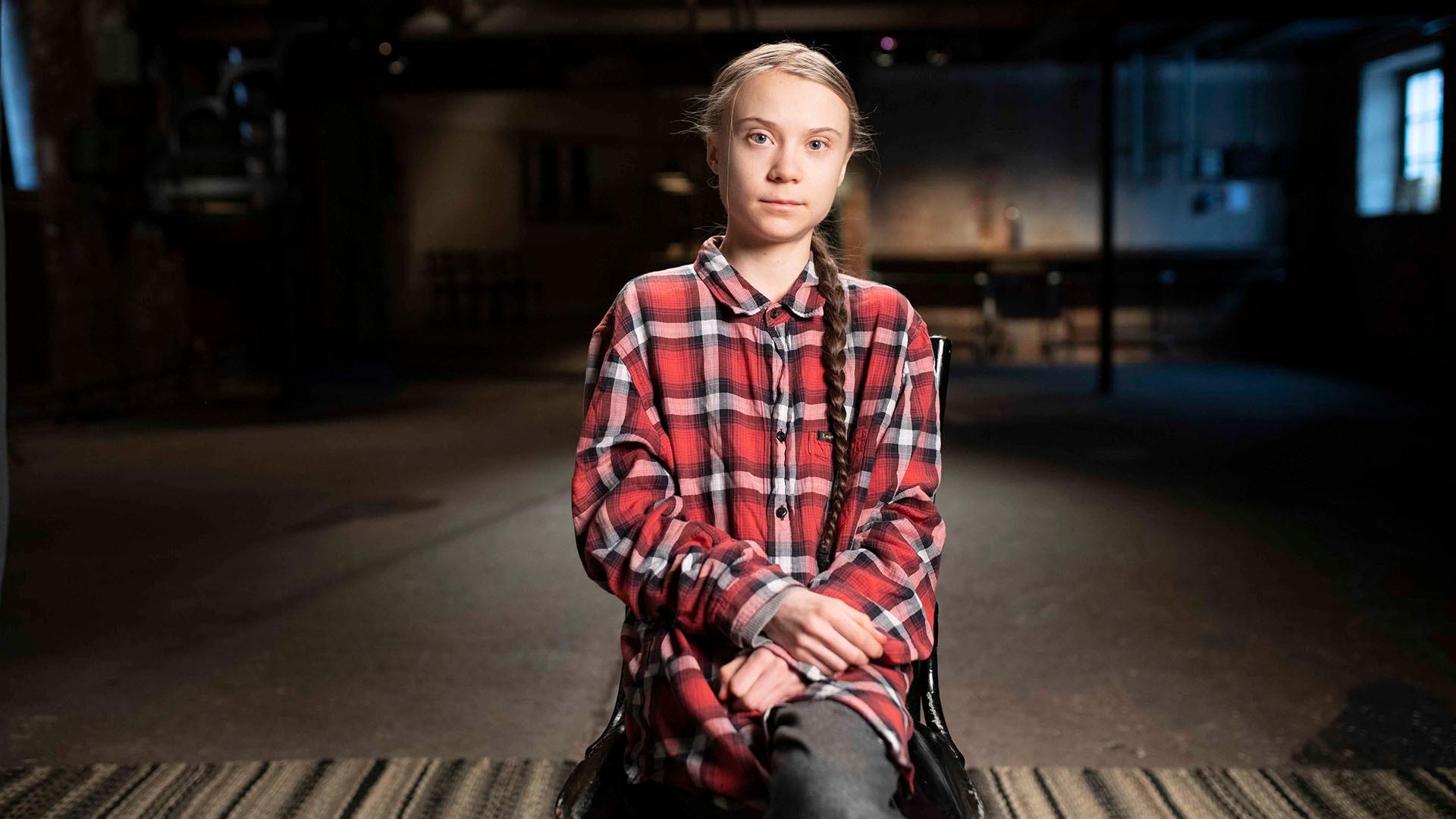 Greta Thunberg sitting in a chair for an interview.