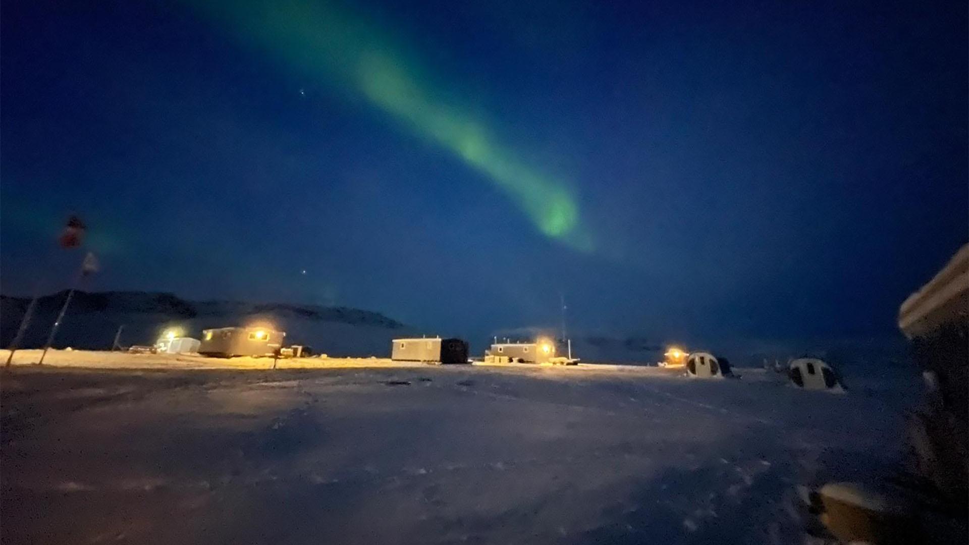 An image of Aurora Borealis over Zackenberg Research Station.