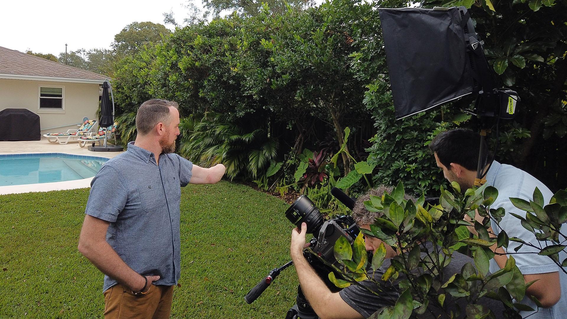 Jason Little poses for a portrait in his backyard. 