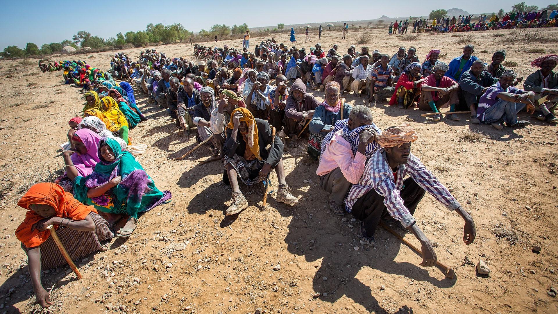 Image of families in Somalia waiting to receive supplies from the government.