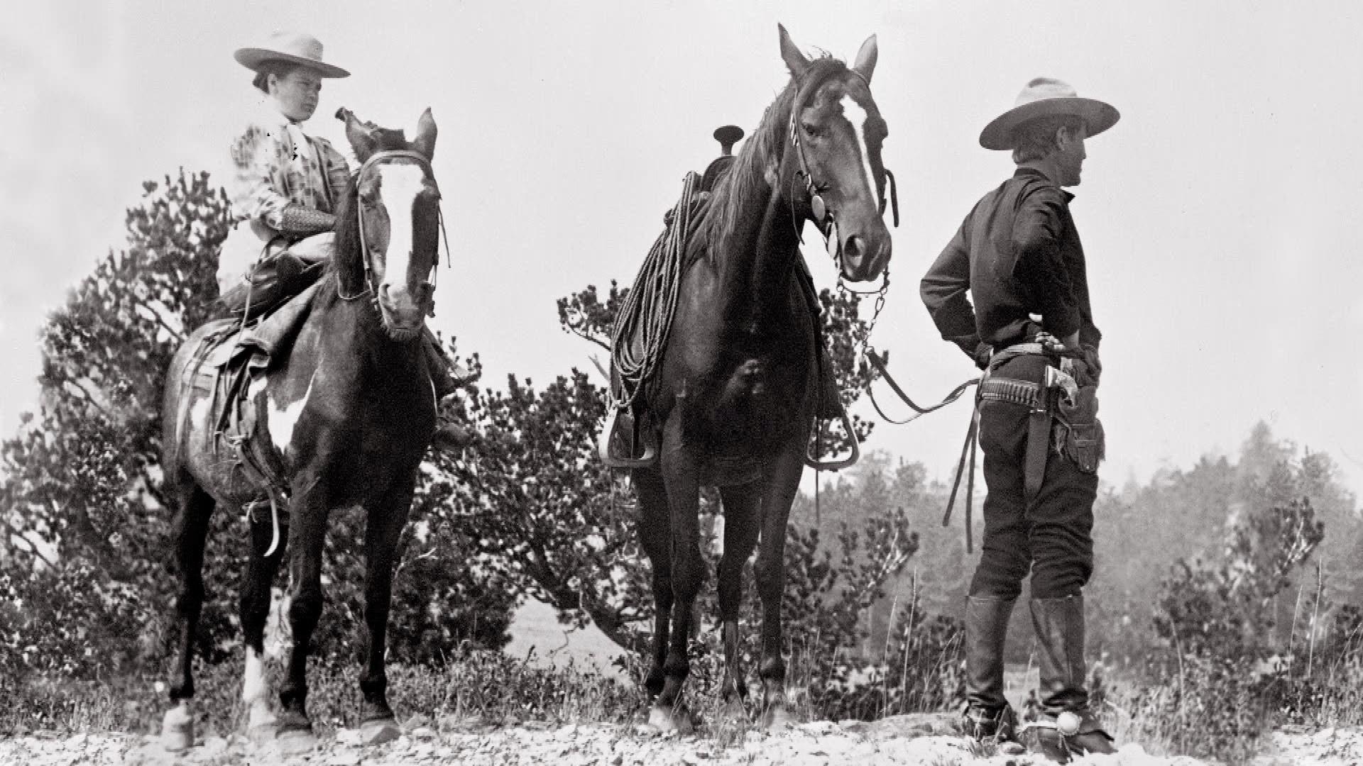 Black and white image of Charlie and Nancy horseback riding.