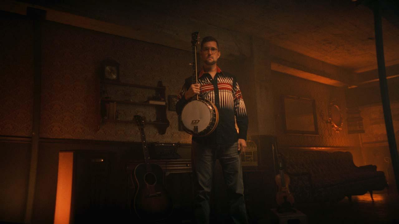 Joe Troop poses with his banjo.