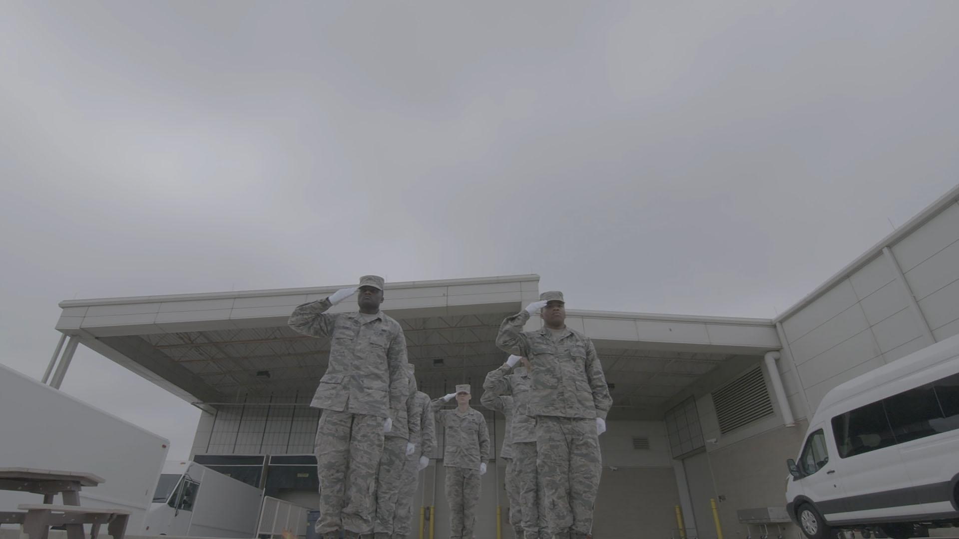 Soldiers salute as they practice for a Dignified Transfer ceremony.