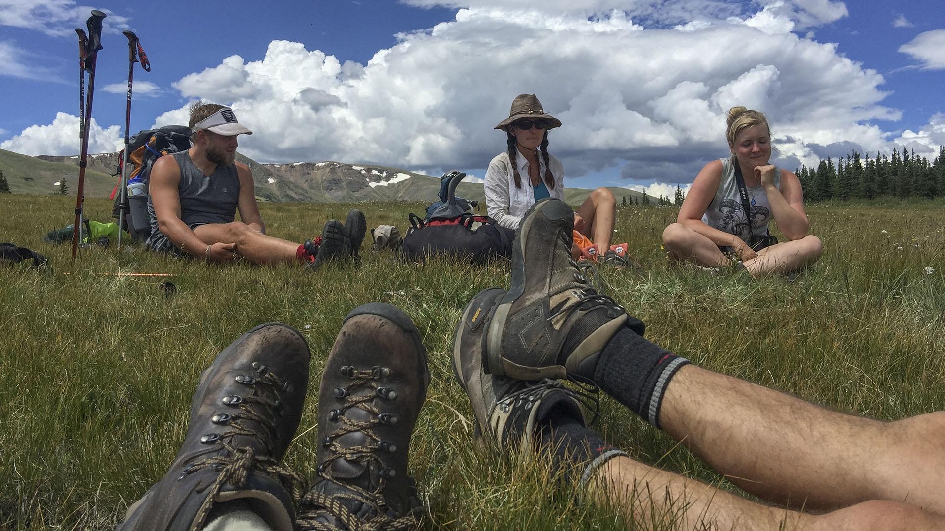 Peter Stegen, Lindsay Dalton and friends sitting in grassy area.