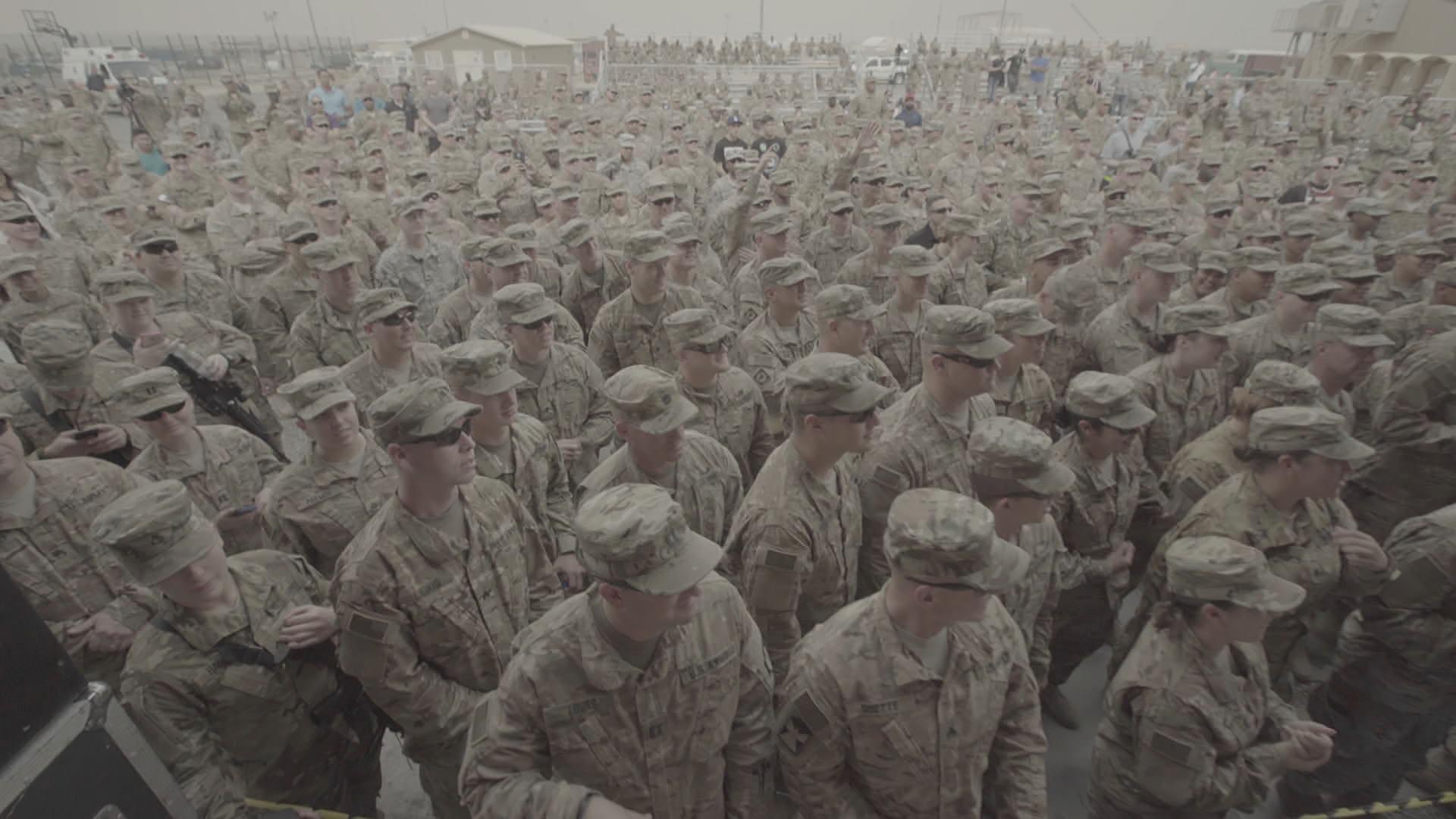 A packed crowd watches Craig Morgan perform as the USO tour touches down in Kuwait.