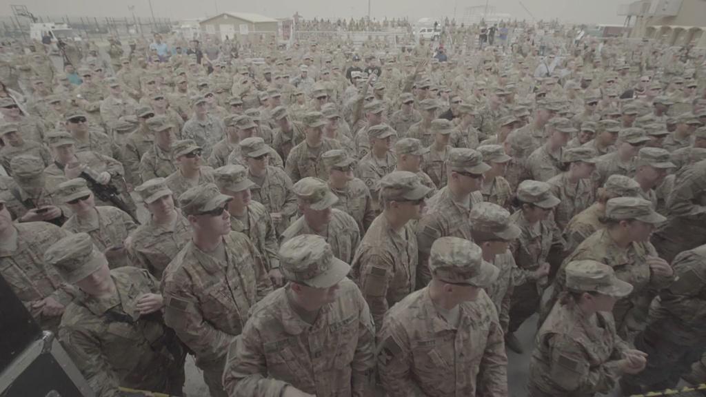 A packed crowd watches Craig Morgan perform as the USO tour touches down in Kuwait.