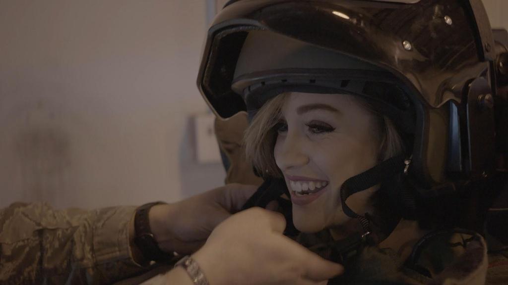 Miss America’s wardrobe change into full combat gear becomes complete as she straps on her helmet.