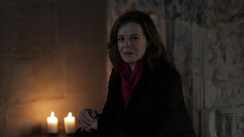 Host Helen Castor sitting next to Shakespeare's grave in Holy Trinity Church, Stratford-upon-Avon.
