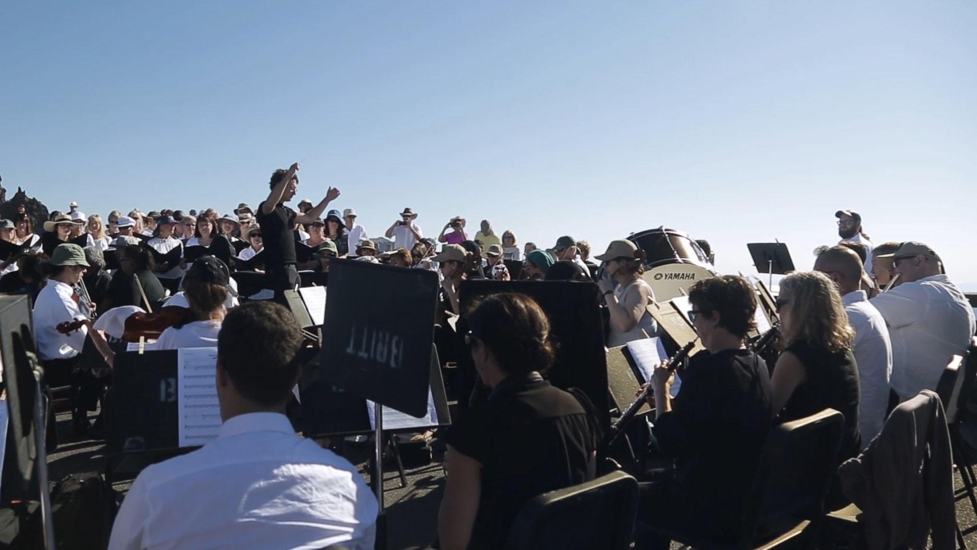 Conductor Teddy Abrams leads musicians in the first performance of “Natural History” at Crater Lake