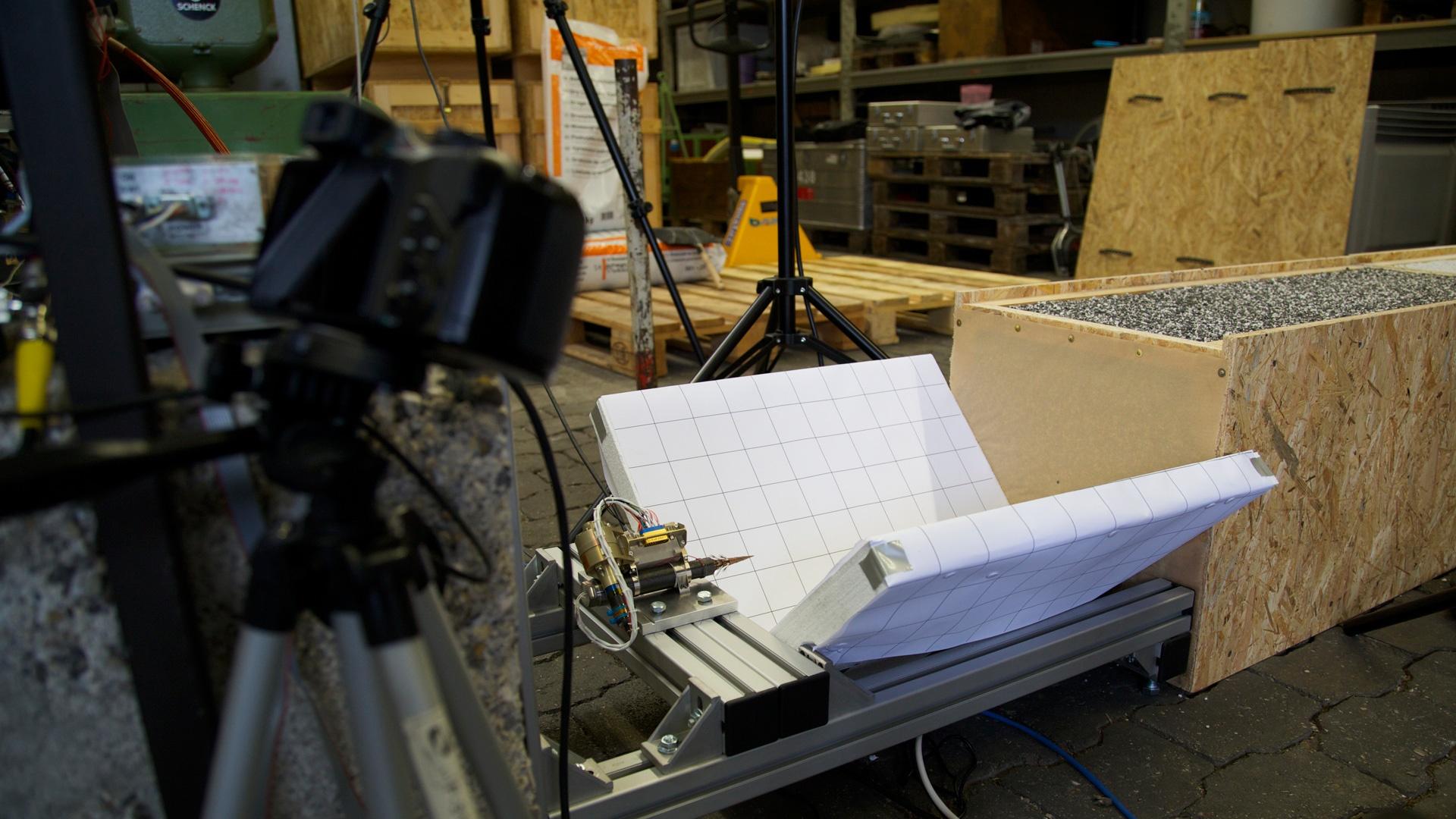 Engineers prepare a replica of the Philae lander harpoon to shoot into a target