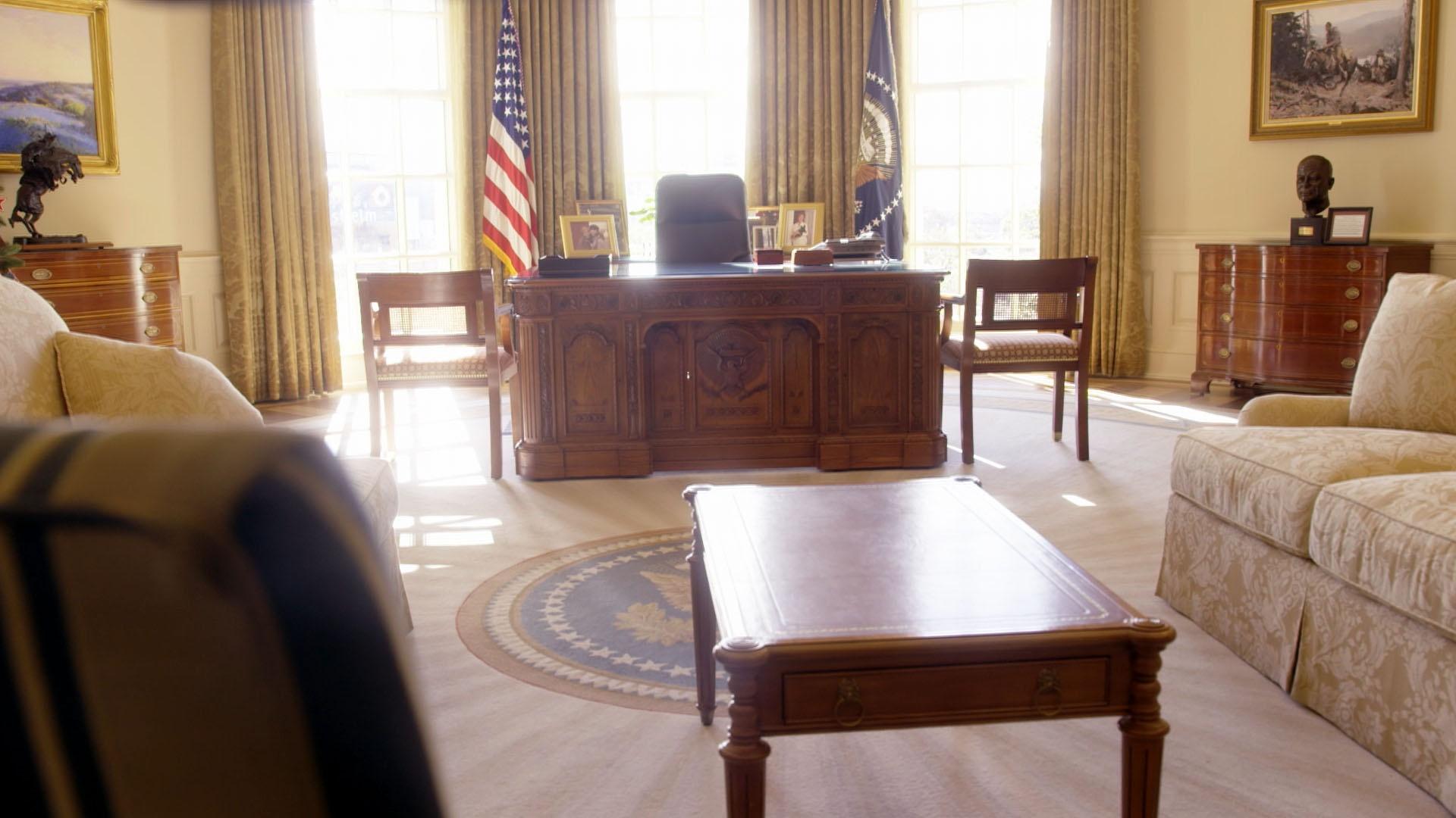 Wide shot of Resolute Desk with couches and side table in foreground.