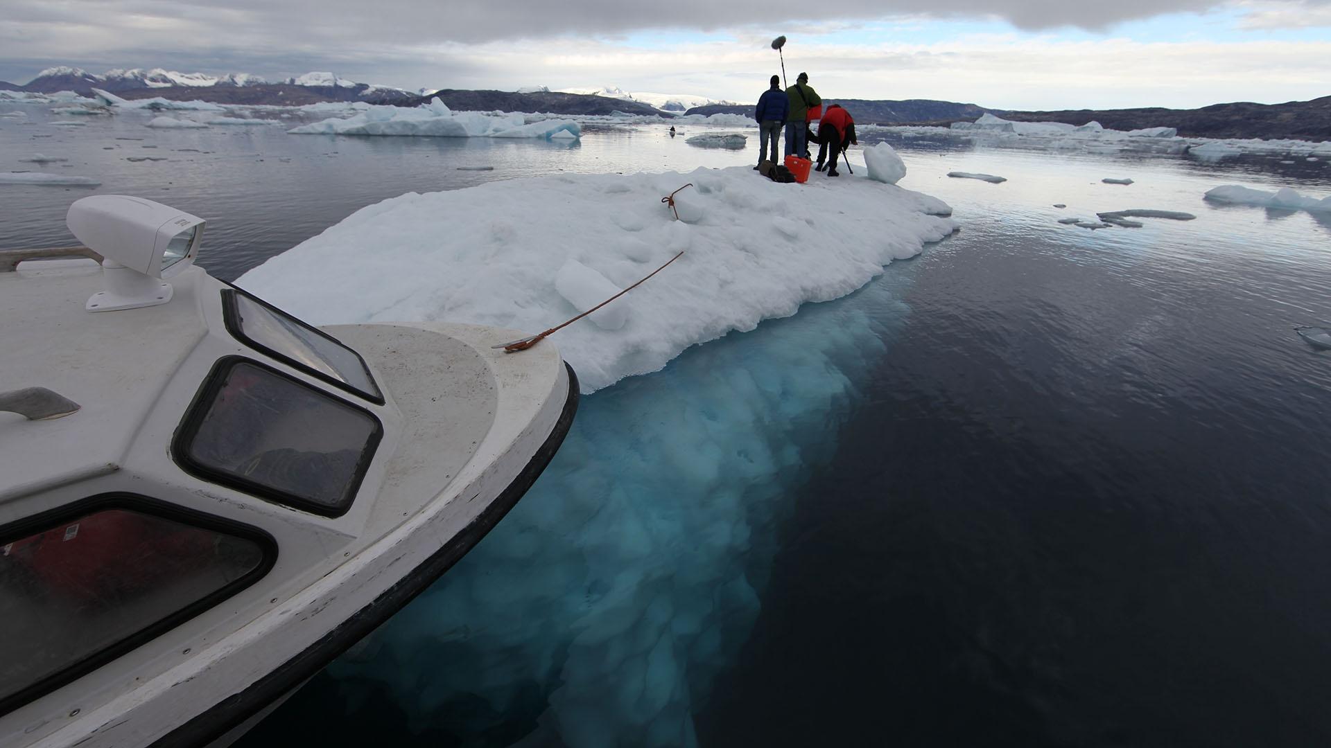 Film crew on iceberg (Sermilik Fjord, East Greenland).