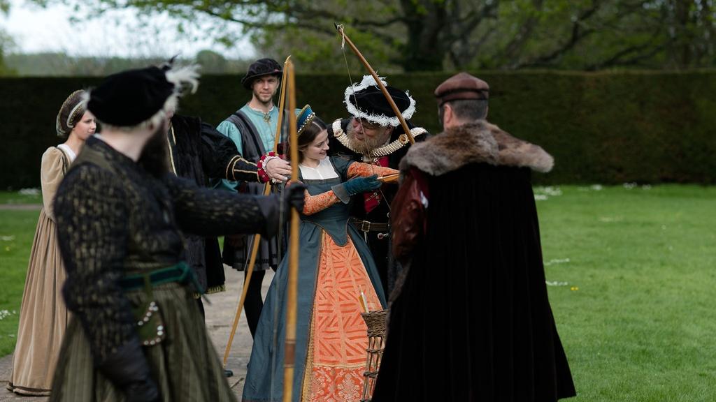 Image of King Henry VIII teaching Katherine Howard to use a bow.