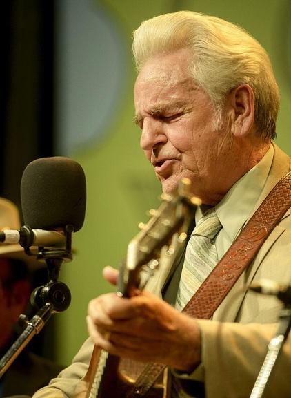 Closeup image of Del McCoury playing instrument