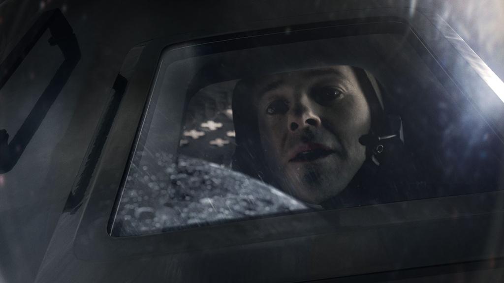 Michael Collins (Patrick Kennedy) looking out of the Command Service Module window.
