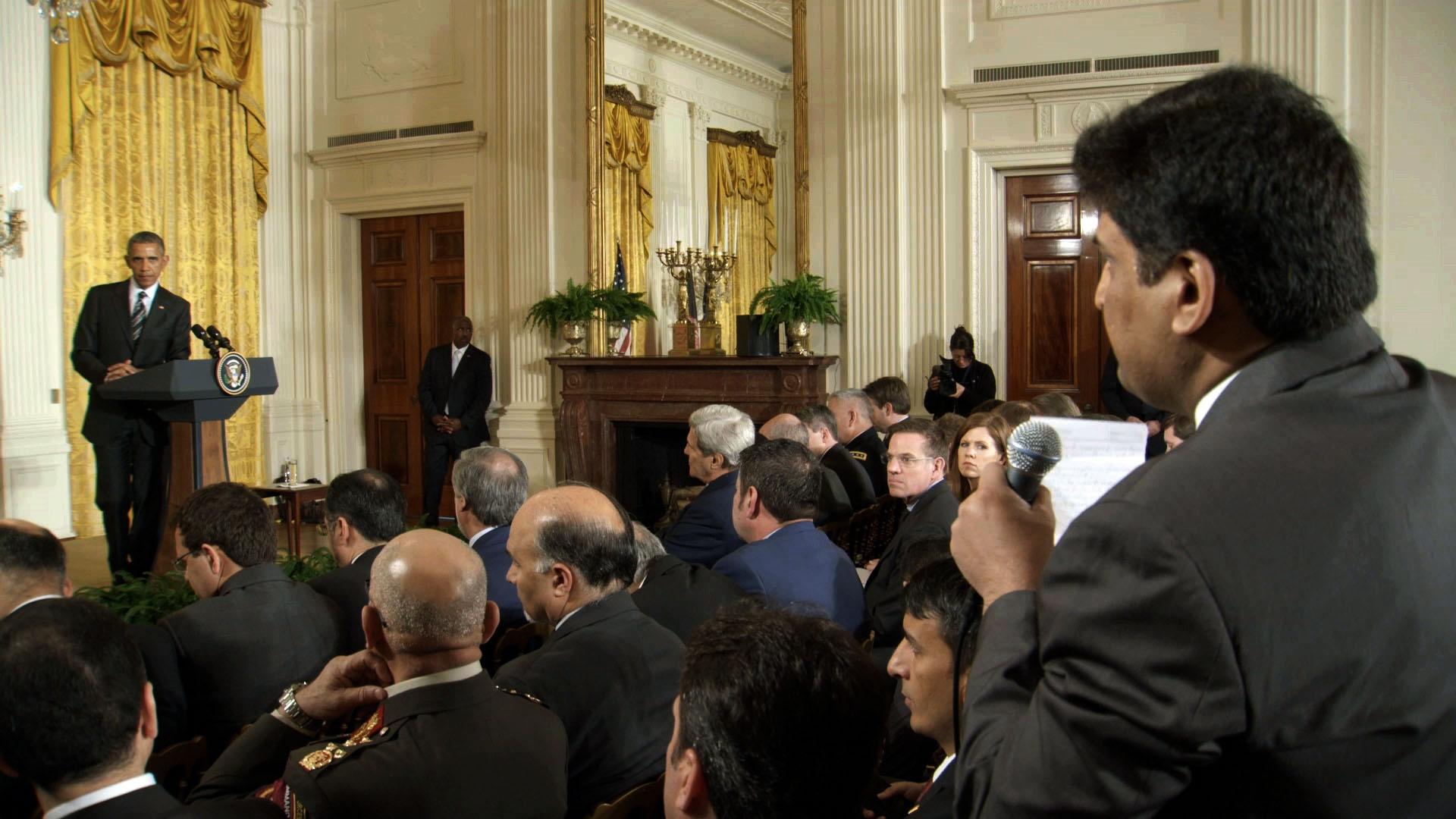 News reporter asks President Obama a question in the East Room of the White House.