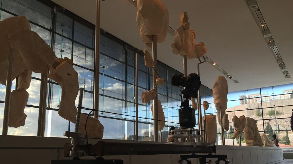 Ancient sculptures line the upper floor of the Acropolis Museum in Athens.