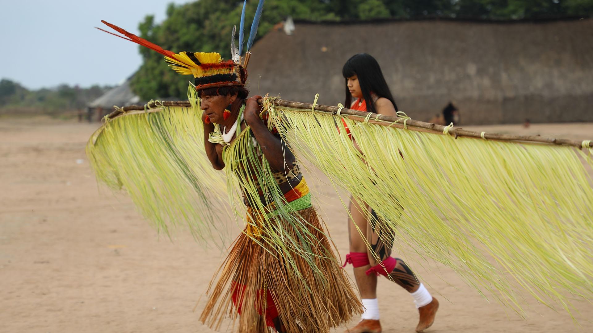 Kamaiyura people in ritual costume dancing to appease the parrot spirit. Xingu National Park.
