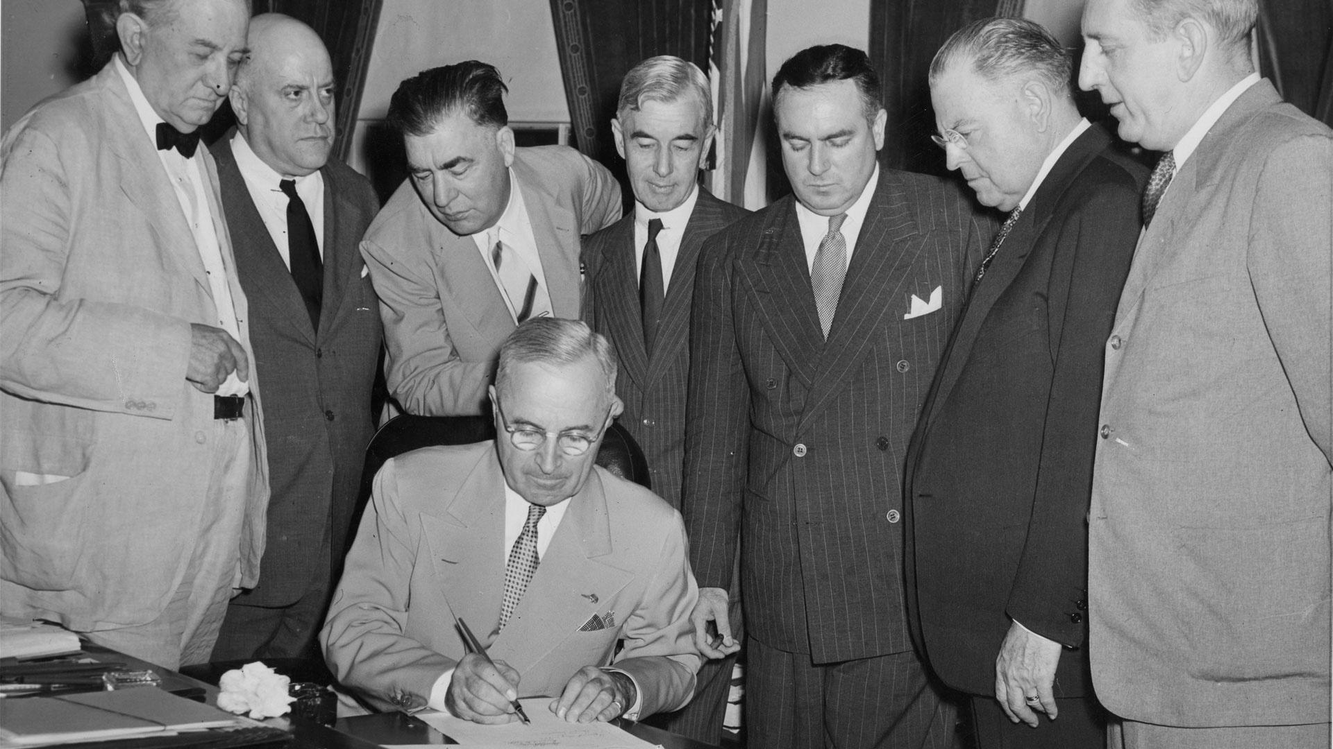 President Harry S. Truman signs the Atomic Energy Act of 1946.