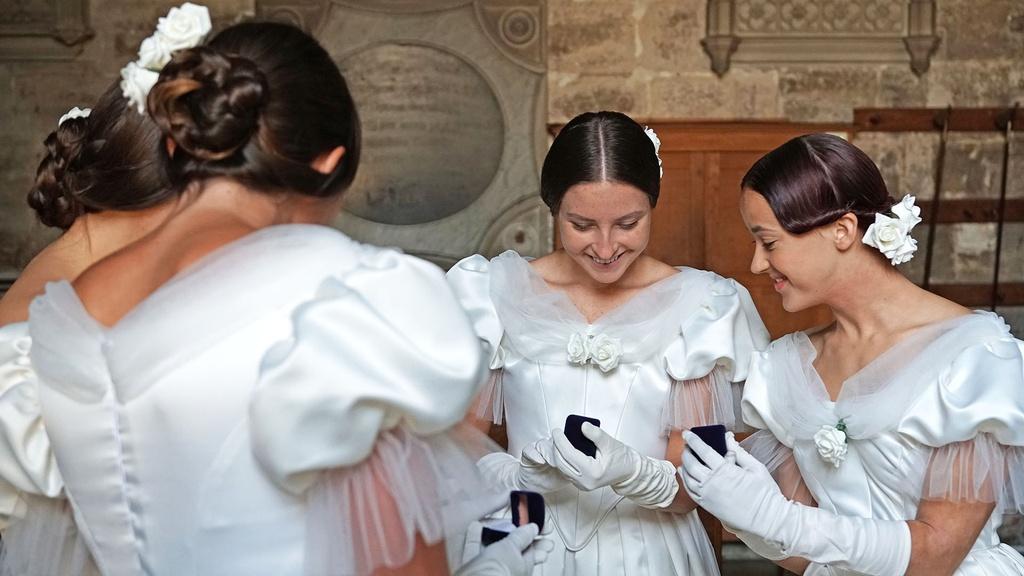 Bridesmaids receive gifts from the Queen.