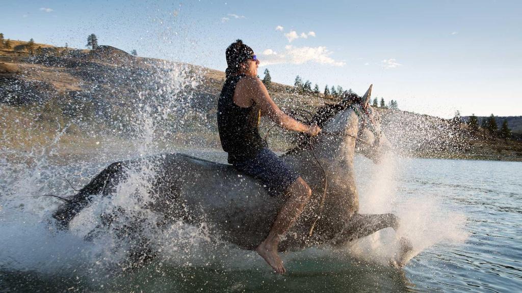 Indian relay racer Oliver Pakootas training his horse.