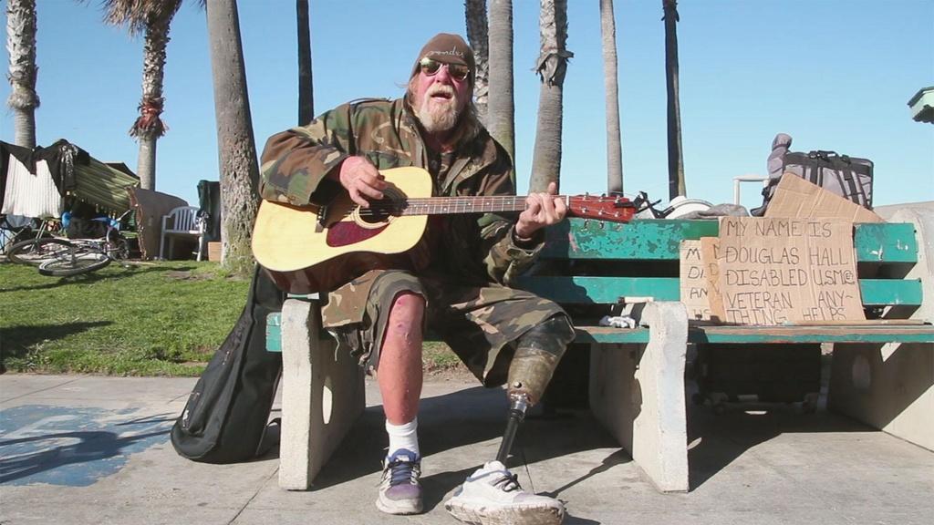 Image of man performing with guitar