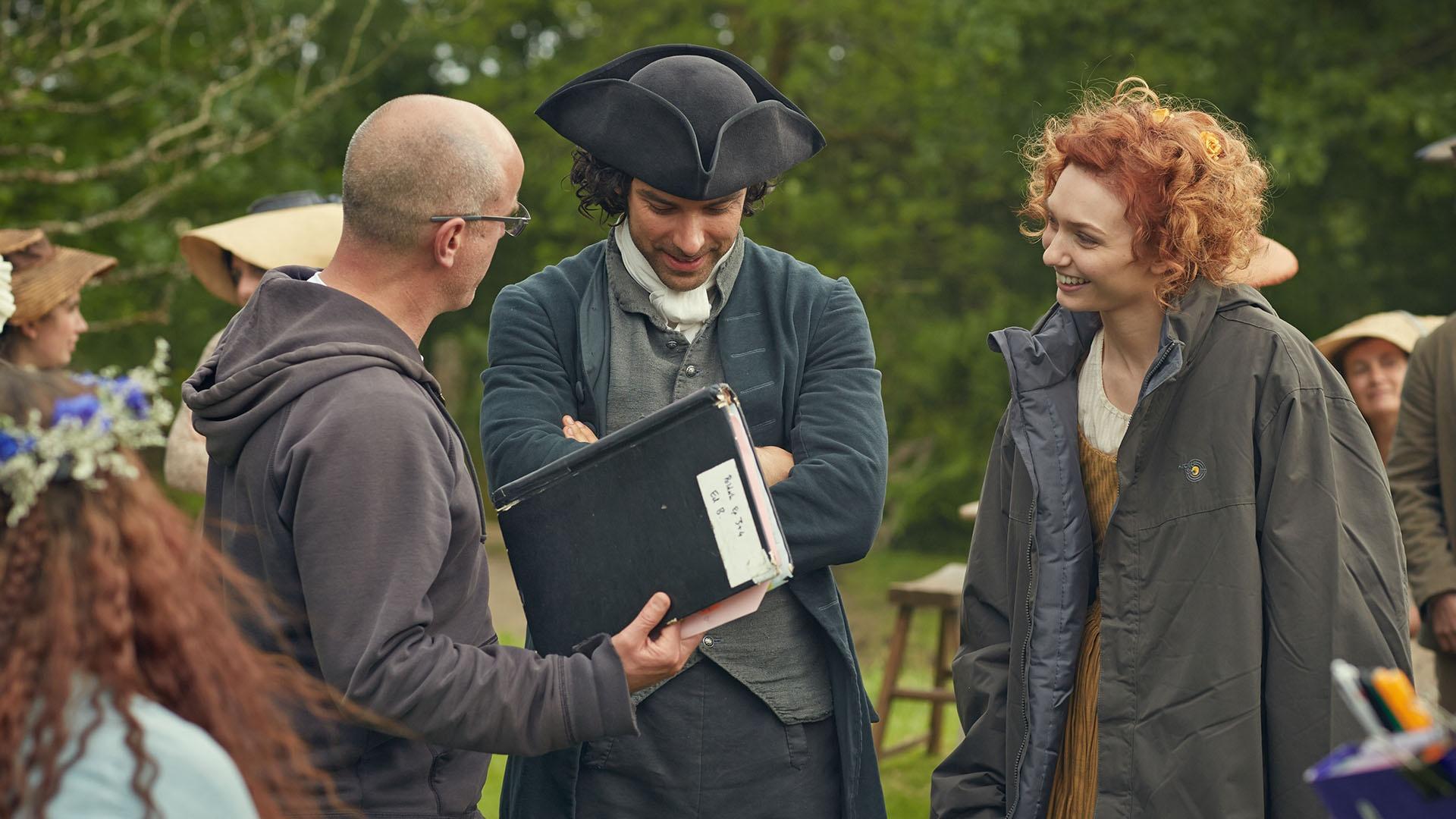 Aidan Turner as Ross Poldark and Eleanor Tomlinson as Damelza on set with the director.