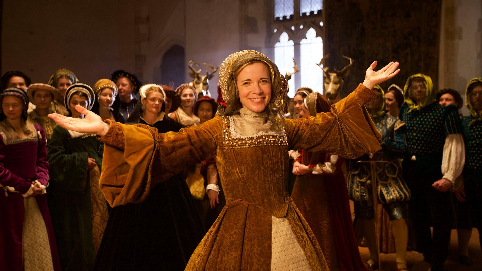 Image of Lucy Worsley dressed in an extravagant Tudor lady costume.