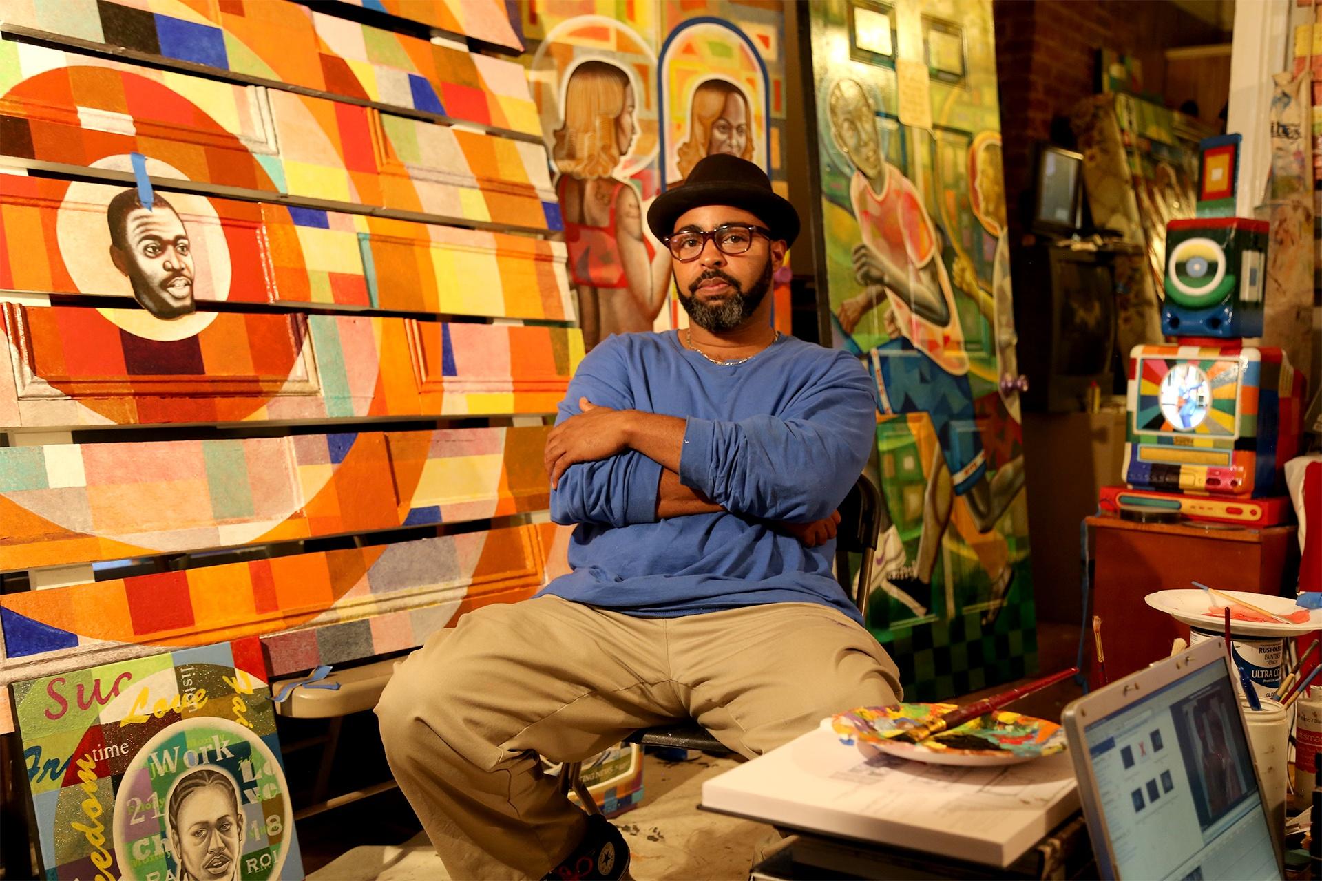 New Orleans artist Carl Joe Williams with one of his large scale paintings in his studio.